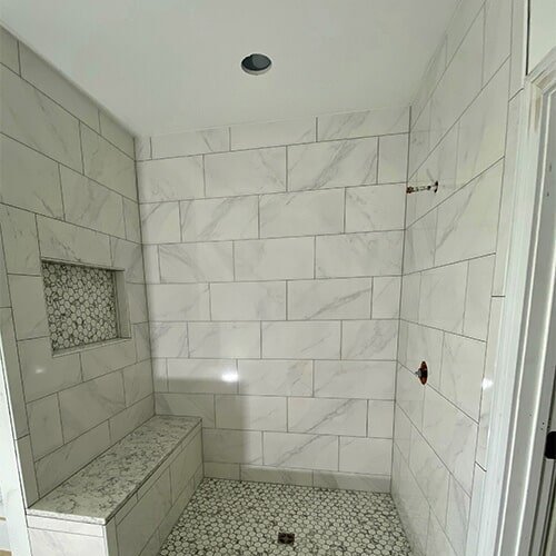 White marble tile shower in Greencastle, IN from Hicks & Sons Floor Coverings