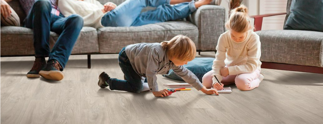 Children coloring and playing on durable Mohawk VersaTech floors.