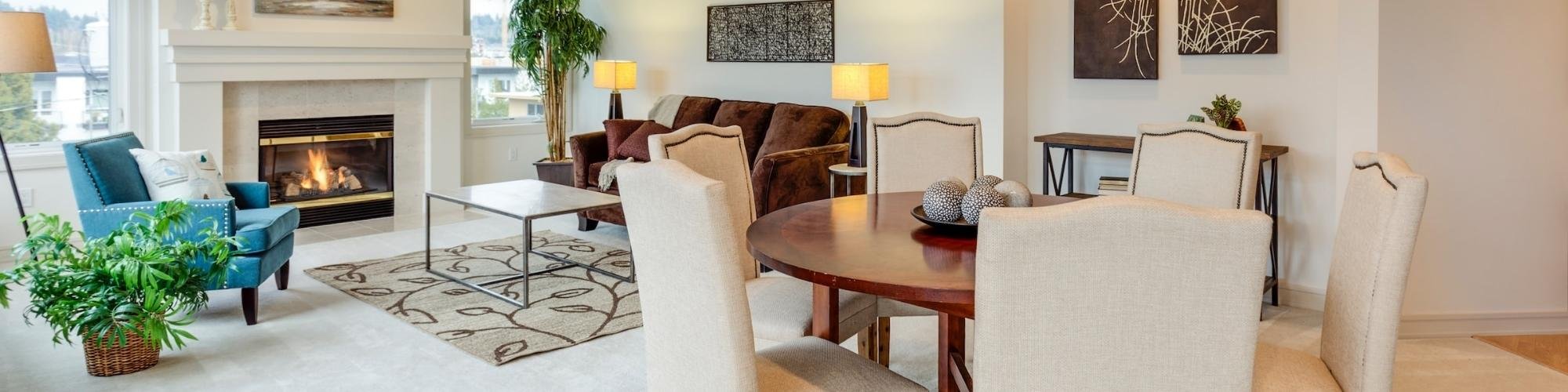 Condo living room and dining room with white carpet flooring